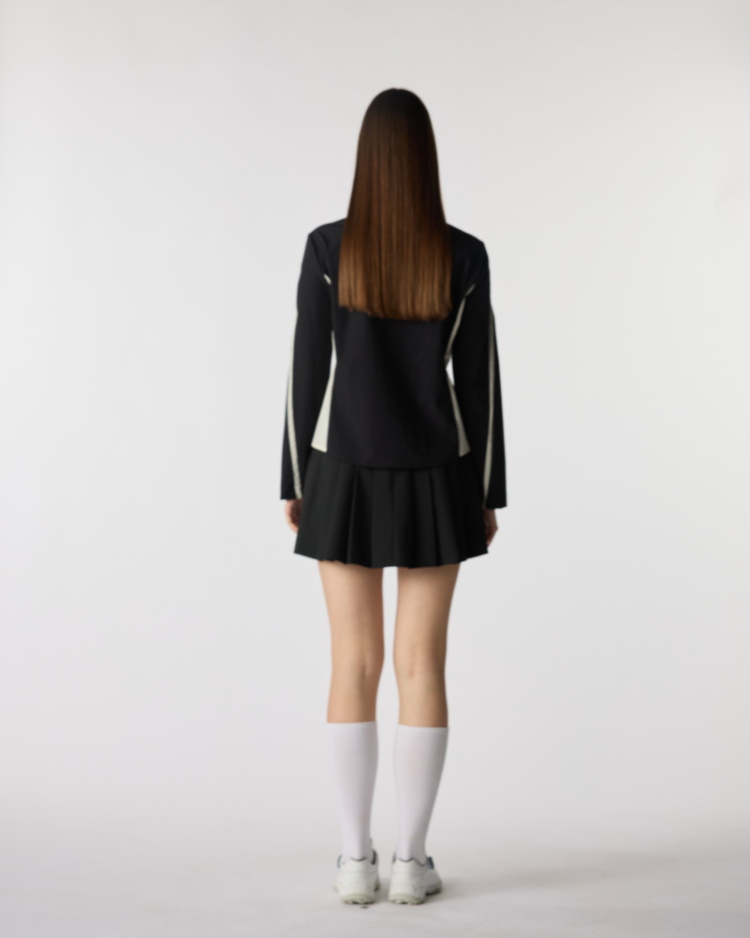 Top de golf de rendimiento negro Spring Reverie